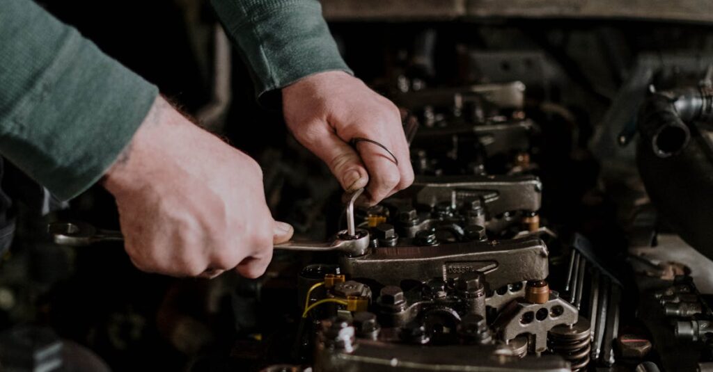 pexels photo 7564866 7564866 Close-up of a mechanic's hands using tools to repair an engine. Indoor setting.